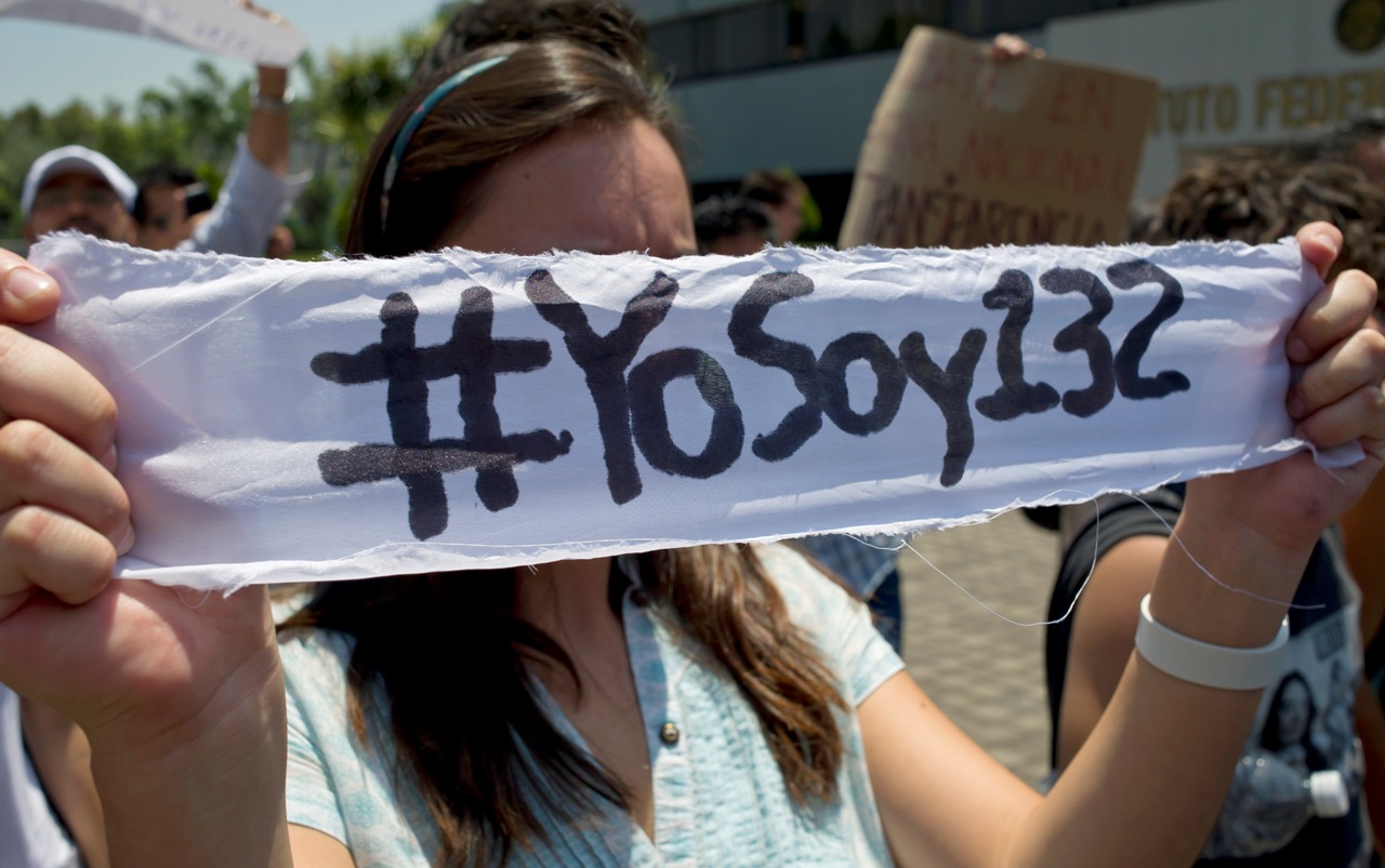 A Mexican university student, member of the new movement called "Yo soy 132" (I Am #132), holds a banner inside the Mexican Electoral Institute offices on May 31, 2012 in Mexico City. The students handed a petition to Electoral authorities, asking for an additional television debate among the four presidential candidates. Mexico will hold presidential elections next July 1st. AFP PHOTO/Omar Torres (Photo credit should read OMAR TORRES/AFP/GettyImages)